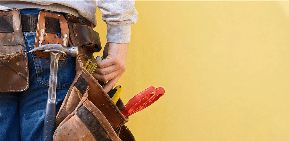 Handyman with tool belt ready for home repairs and maintenance in Salt Lake City, UT