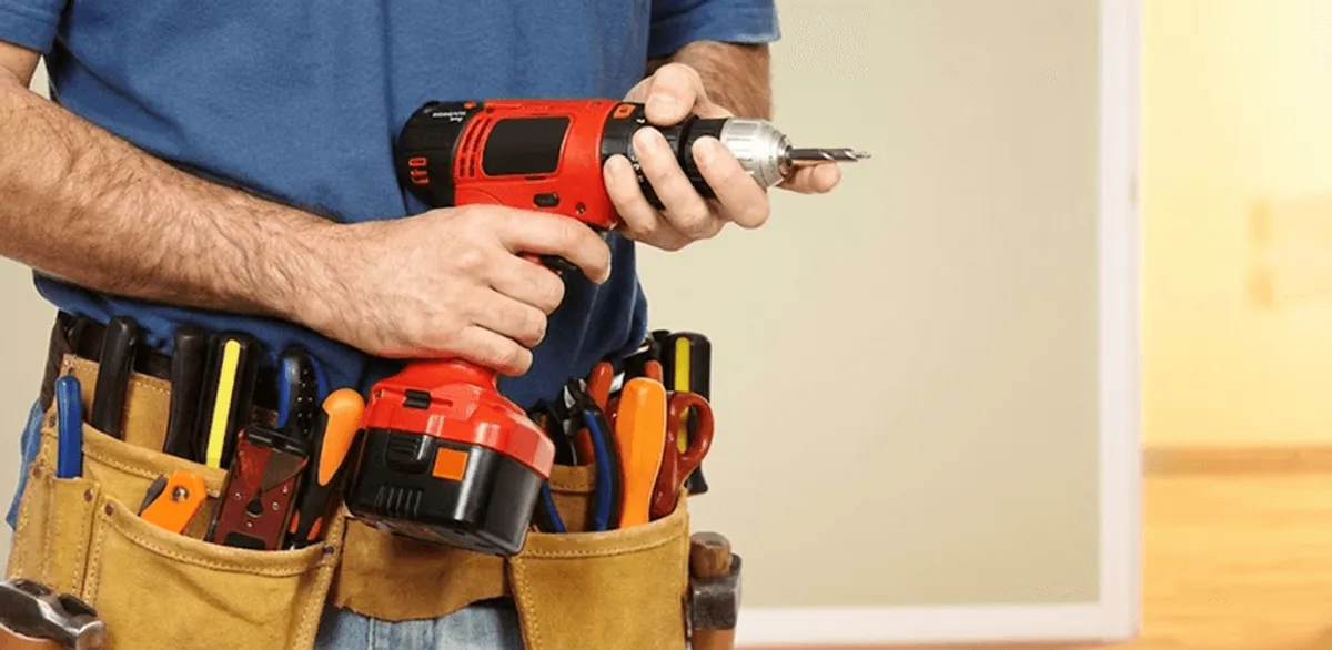 Handyman holding a power drill for home repairs and installations in Salt Lake City, UT